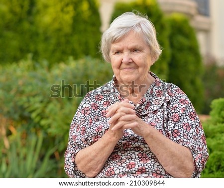 Senior  woman  in garden.  MANY OTHER PHOTOS FROM THIS SERIES IN MY PORTFOLIO.