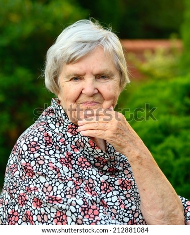 Senior happy woman smiling in garden.  MANY OTHER PHOTOS FROM THIS SERIES IN MY PORTFOLIO.
