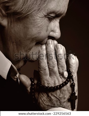 Praying senior woman.