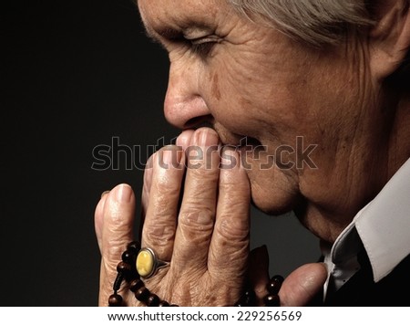 Praying senior woman.