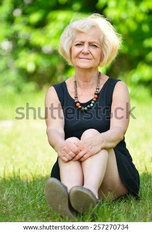 Mature, blonde woman in garden, MANY OTHER PHOTOS FROM THIS SERIES IN MY PORTFOLIO.