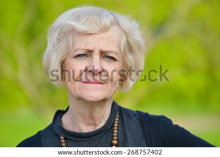 Mature, blonde woman in garden, MANY OTHER PHOTOS FROM THIS SERIES IN MY PORTFOLIO.
