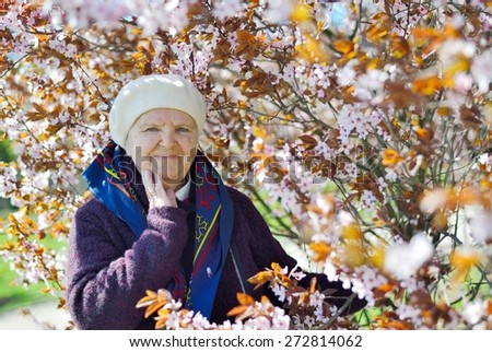 Senior happy woman smiling in garden. MANY OTHER PHOTOS FROM THIS SERIES IN MY PORTFOLIO.