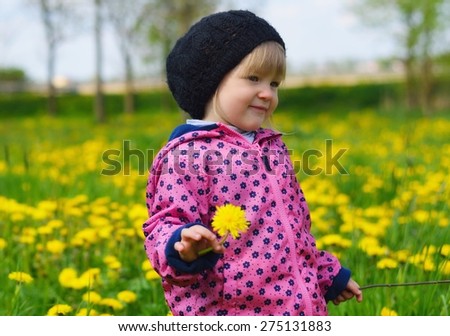 Young girl on green meadow full of yellow flowers. MANY OTHER PHOTOS FROM THIS SERIES IN MY PORTFOLIO.