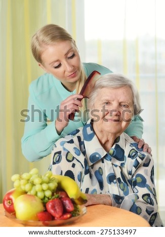 Senior woman with her caregiver in home. MANY OTHER PHOTOS FROM THIS SERIES IN MY PORTFOLIO.