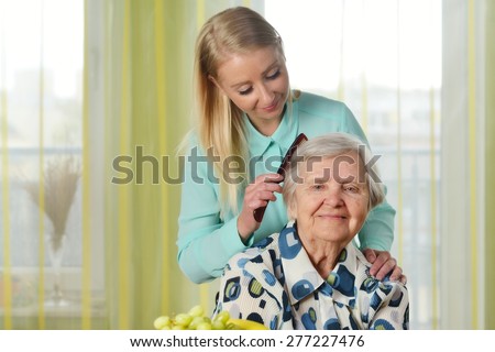 Senior woman with her caregiver in home. MANY OTHER PHOTOS FROM THIS SERIES IN MY PORTFOLIO.