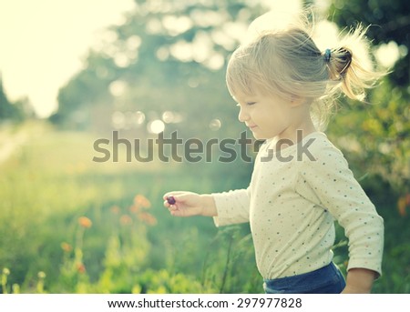 Cute little girl in the sunshine. Back sunlight. MANY OTHER PHOTOS FROM THIS SERIES IN MY PORTFOLIO.