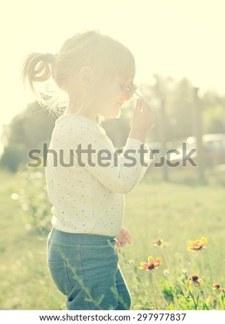 Cute little girl in the sunshine. Back sunlight. MANY OTHER PHOTOS FROM THIS SERIES IN MY PORTFOLIO.