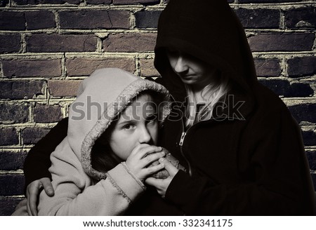 Homeless mother with her daughter. Poor family.
