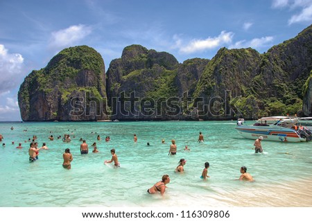 PHI PHI ISLAND, THAILAND - AUG 5: Tourists enjoy the sea of Phi Phi Island, Thailand on August 5, 2009. Ko Phi Phi was devastated by the 2004 Tsunami,when most of island\'s infrastructure was destroyed