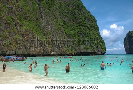 PHI PHI ISLAND, THAILAND - JUN 22: Tourists enjoy the wonderful beach, June 22, 2008 in Phi Phi Island, Thailand. It  was populated by Muslim fishermen during 1940s, then became a coconut plantation