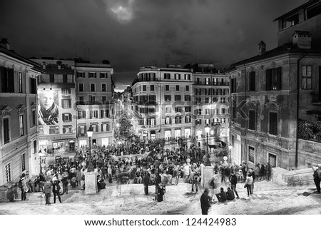 ROME - NOV 3: People climb the spanish steps of Piazza di Spagna on the evening of November 3, 2012 in Rome. The 'scalinata' is the widest staircase in Europe