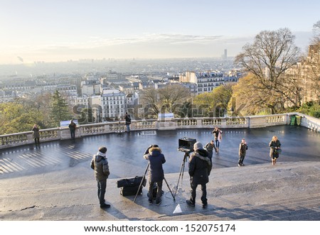 PARIS - DEC 13: Photographers and tourists enjoy city view from Montmartre, December 13, 2012 in Paris. More than 50 million people visit the city every year.