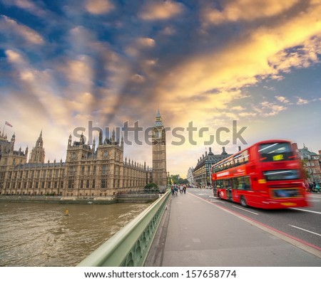 Double Decker red bus crossing Westminster Bridge. Big Ben and river Thames view.