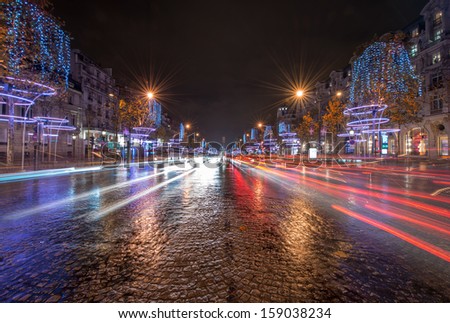 PARIS, NOV 30: Car light trails in famous Champs Elysees, November 30, 2012 in Paris. The avenue runs for 1.91 km (1.18 mi) through the 8th arrondissement.