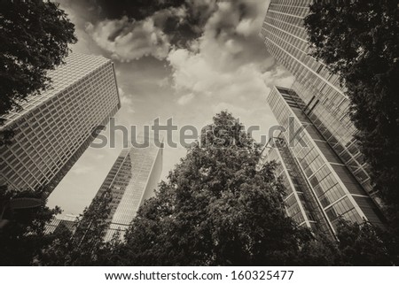London, Canary Wharf. Beautiful view of Skyscrapers and trees from street level.