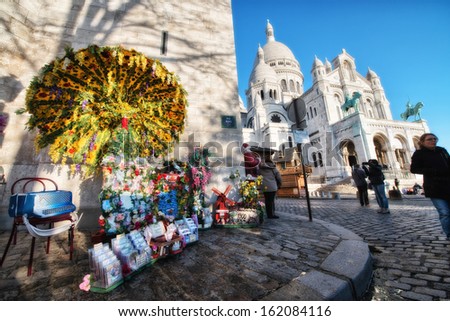 PARIS, DEC 3: Tourists walk in front of Sacred Heart Cathedral, December 3, 2012 in Paris. More than 50 million people visit the city every year.