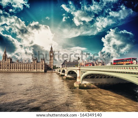 Classic Red Double Decker Buses Crossing Westminster Bridge To The Houses Of Parliament - London.
