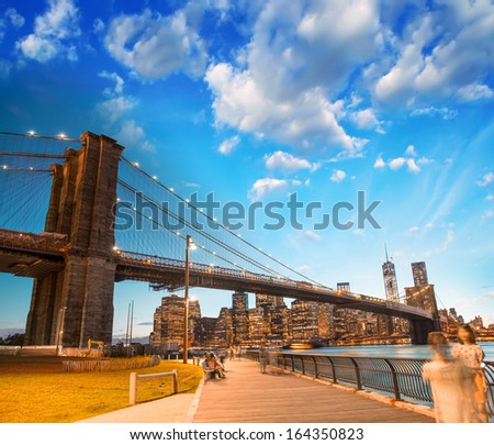 The Brooklyn Bridge Park, New York. Manhattan Skyline At Summer Sunset.