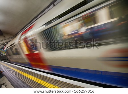 Train moving in speed at Canary Wharf platform