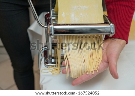Woman Chef making simple homemade noodles with pasta machine