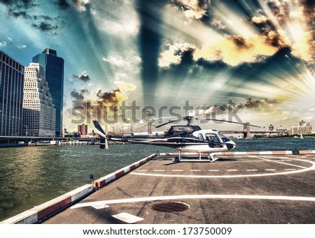Helicopter on the launch platform in New York with city skyline.