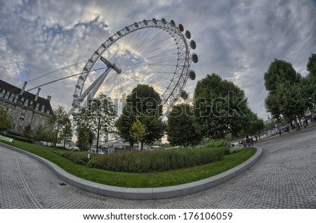 LONDON - SEP 29, 2013: Tourists visit London Eye Wheel. The entire structure is 135 metres (443 ft) tall and the wheel has a diameter of 120 metres (394 ft).