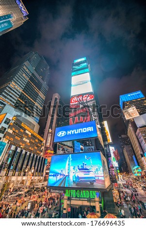 NEW YORK - JUN 12, 2013: Times Square ads and lights at night. Times Square is the brightly illuminated hub of the Broadway Theater District, one of the world\'s busiest pedestrian intersections