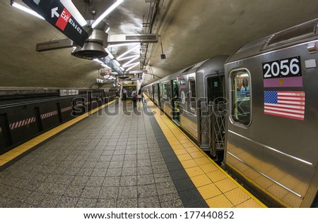 NEW YORK CITY - JUN 12, 2013: People inside a Manhattan subway station. The New York City Subway is also one of the world\'s oldest public transit systems