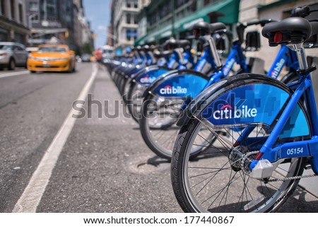 NEW YORK CITY - CIRCA JUNE 2013: Row of blue bikes along city streets. NYC bike share system started in Manhattan and Brooklyn on May 27, 2013.