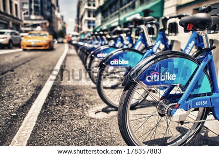 NEW YORK CITY - CIRCA JUNE 2013: Row of blue bikes along city streets. NYC bike share system started in Manhattan and Brooklyn on May 27, 2013.