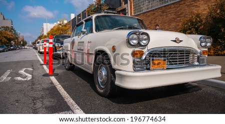 BROOKLYN - JUN 11, 2013: Vintage white taxi cabs await customers. Today, more than 13,000 modern taxis take the place of the old ones