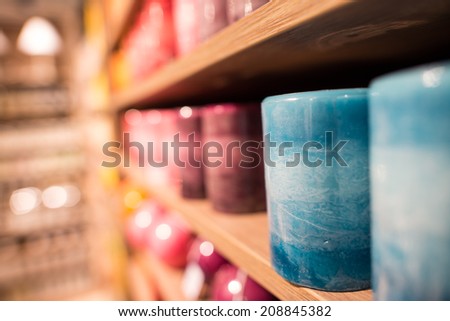 Colorful Scented Candles on a shelf.
