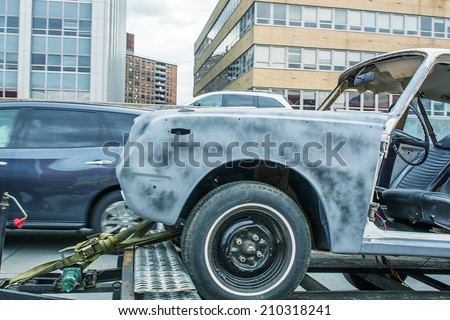 Damaged car on a tow truck after a street accident.