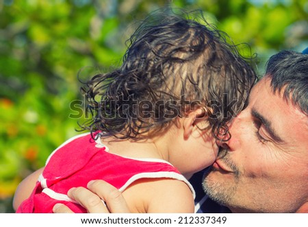 Father sweet kiss to his daughter.