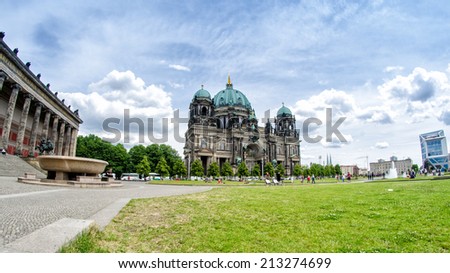 BERLIN - MAY 27, 2012: Tourists walk along Berliner Dom on a beautiful day. More than 25 million people visit the city every year.