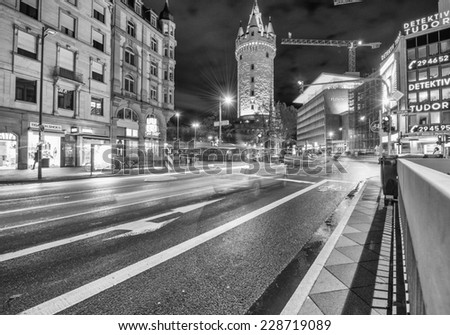 FRANKFURT - OCTOBER 31, 2013: Traffic lights in city streets at night. Frankfurt is one of the major German cities, visited by 3 million people per year.