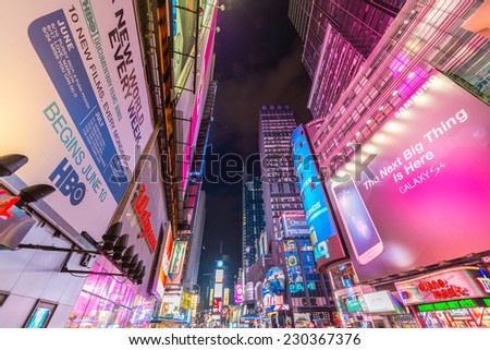 NEW YORK CITY - JUN 8: Nighttime lights in Times Square, with pedestrian\'s crowds and traffic on June 8, 2013 in New York, NY, USA