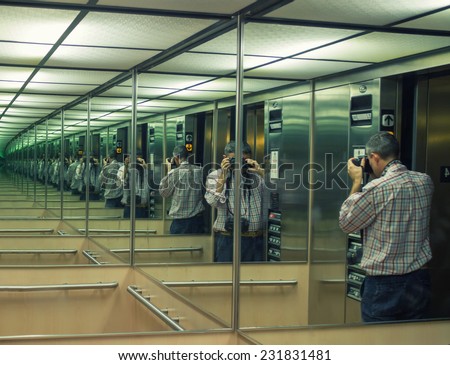 Photographing the mirror. Multiple man reflections.