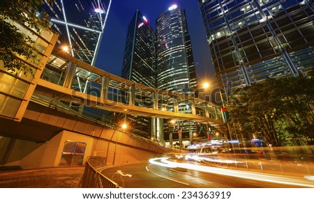 HONG KONG - APRIL 24, 2014: Cars and buses speed up in city streets at night. Public transportation is used by more of 90 percent of population.