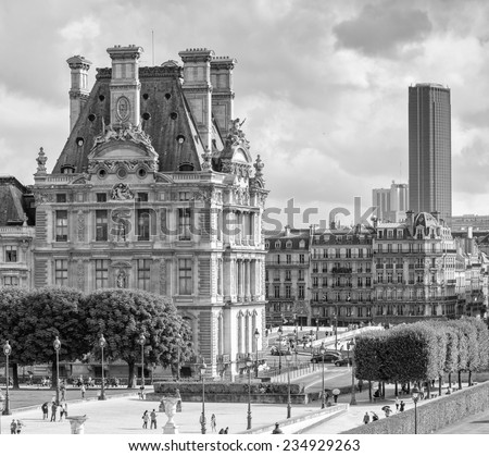 PARIS - JULY 20, 2014: Tourists walk along Tuileries Gardens in Paris. French capital is visited by more than 30 million people annually.
