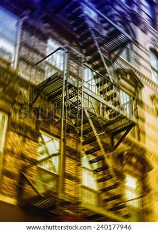 Motion blurred image of New York brick buildings with outside fire escape stairs.