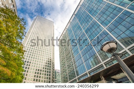 Canary Wharf. Beautiful view of Skyscrapers and trees from street level - London.