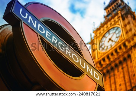 LONDON, UK - SEPTEMBER 27, 2013: Symbols of London - Underground sign and Big Ben clock tower