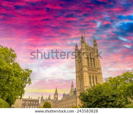 London, Westminster Palace surrounded by trees at dusk.