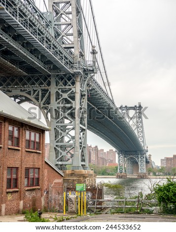 Magnificence of Manhattan Bridge, New York. Street view on a cloudy day.