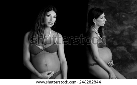 Pregnant woman in lingerie with body reflected on mirror. Isolated on black.