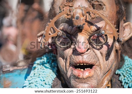 VENICE, ITALY - FEBRUARY 8, 2015: An unidentified masked person in costume in St. Mark\'s Square during the Carnival of Venice 2015. The 2015 carnival started on January 31.