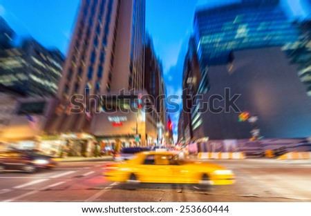 Blurred picture of Yellow Cab speeding up in the night, New York.