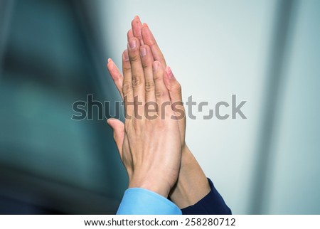 Business man and woman giving five, hands detail.